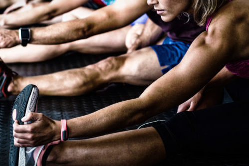 Side view of athletes stretching Stretching