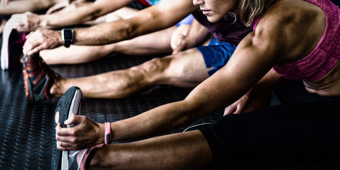 Side view of athletes stretching Stretching